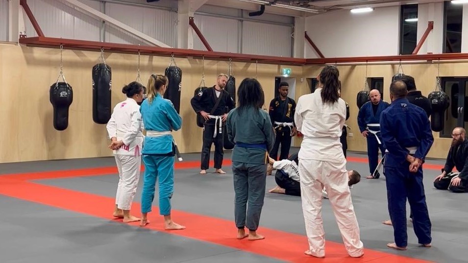 The image shows four women training in Brazilian jiu-jitsu at a martial arts centre in Twickenham.