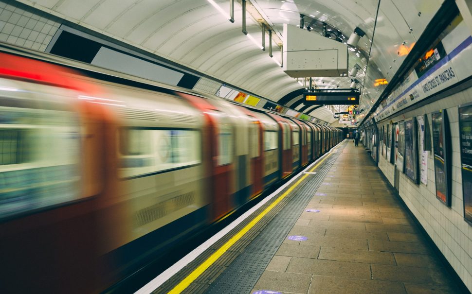 A London Underground train rushes past amidst rising rail fare prices