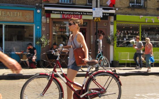 Women on a bike standing in the middle f the street