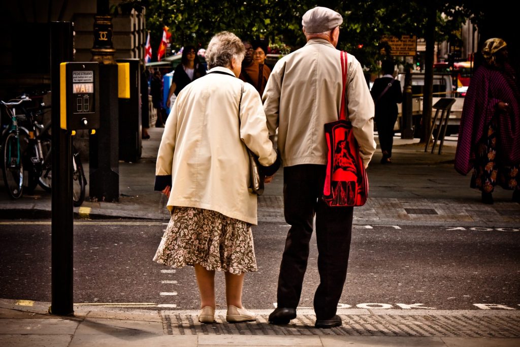 Old people standing at a crossing in London