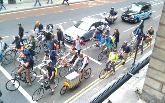 Group of London cyclists queuing at traffic lights