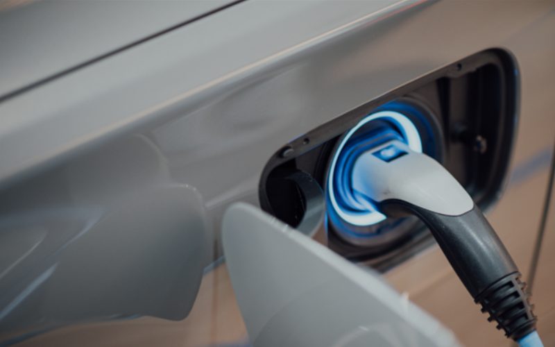 A close up of charging an electric vehicle.