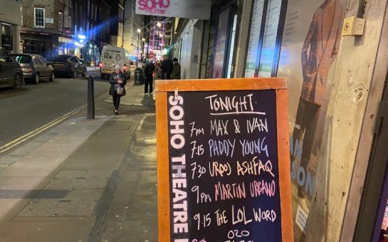 a picture of outside the Soho Theatre. A chalkboard is on the street outlining the acts for the night. It reads: Tonight: 7pm Max & Ivan, 7:15 Paddy Young, 7:30 Urooj Ashfaq, 9pm Martin urbano, 9:15 The LOL word