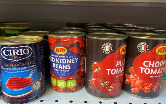 Four tins in a row. Three of chopped tomatos and one of kidney beans.