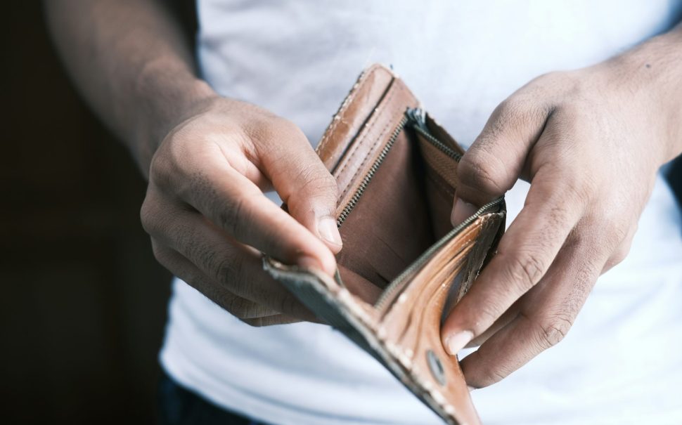 Man holding empty wallet