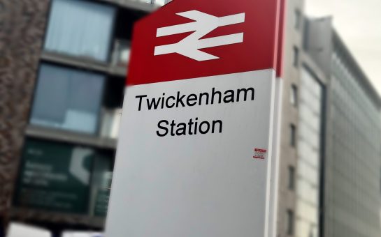 Train Station sign and red/white logo. The writing on the sign reads Twickenham Station