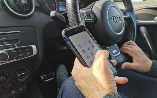 Driver using their phone while driving on the road