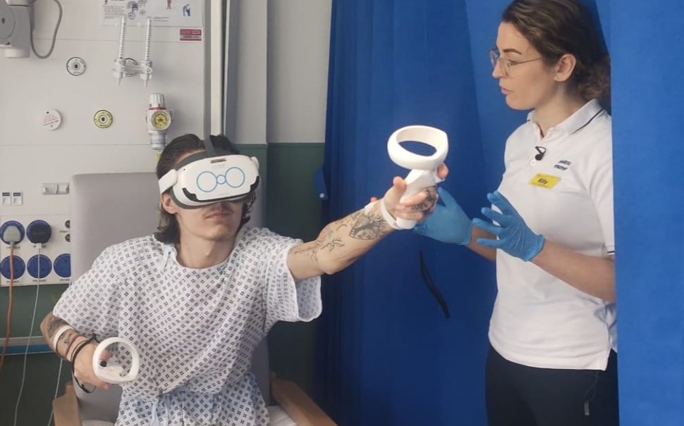 A young man doing physical therapy in hospital while wearing a virtual reality headset.