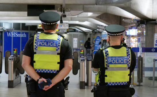 Two police officers stood underground
