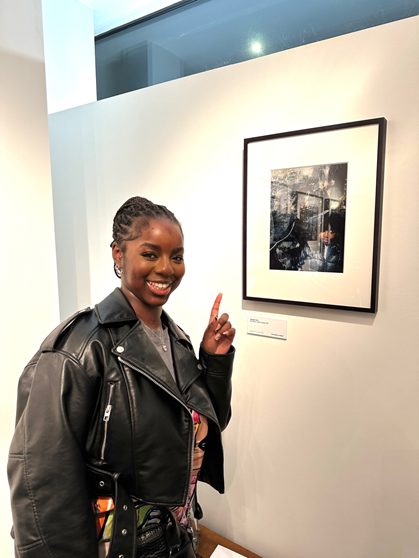 Aleesha poses next to her photo.