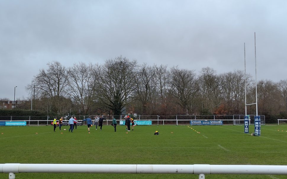 Players warming up at Age UK Richmond's walking rugby class at Richmond Rugby club