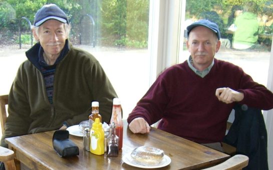 Two men sitting at a cafe table