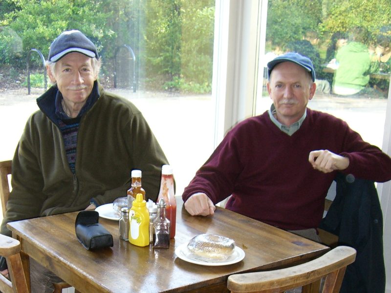 Two men sitting at a cafe table
