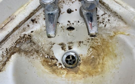 A picture of serious mould buildup around a sink