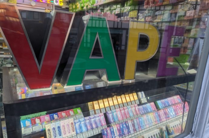 Image of vapes for sale under big colourful block letters that say V A P E