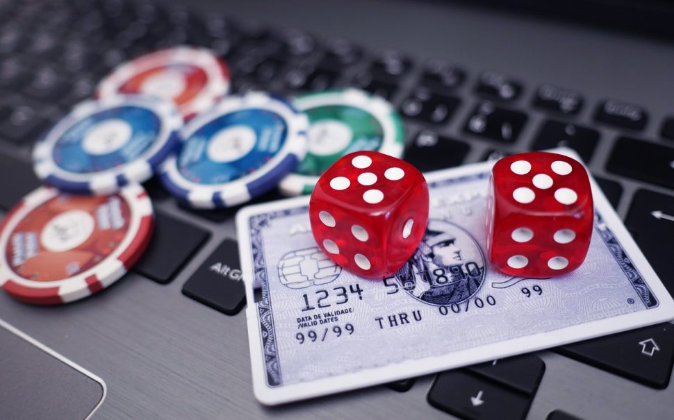 Dice and a credit card on a laptop