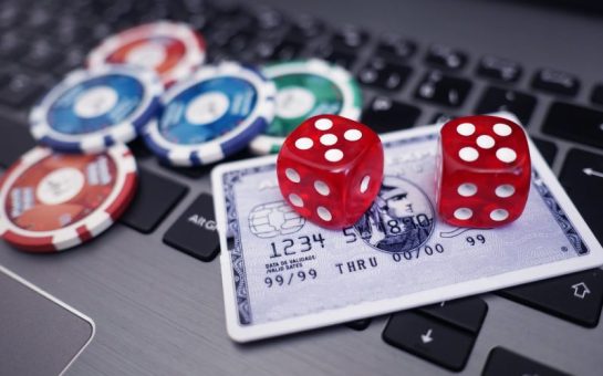 Dice and a credit card on a laptop