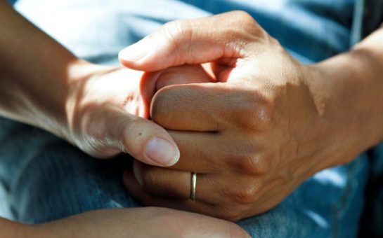 Picture of woman holding patients' hand