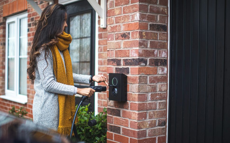 Woman charges electric vehicle