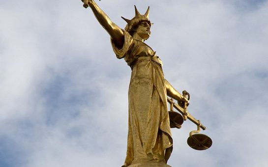 bronze Lady Justice statue on top of the Old Bailey