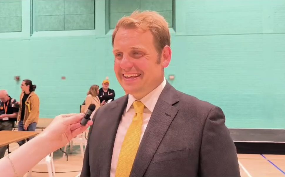 Man wearing yellow tie smiling during interview