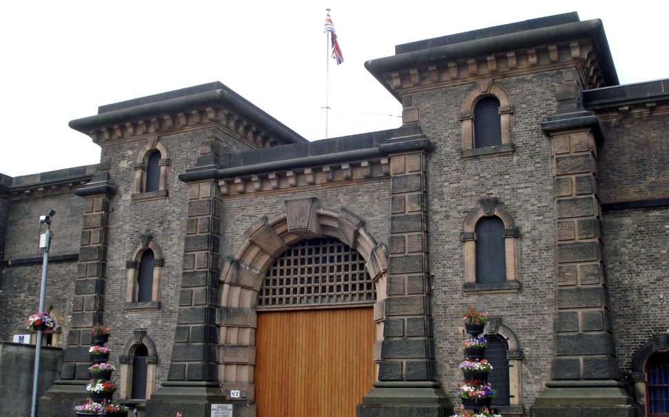 Walls and entrance to a grey brick prison