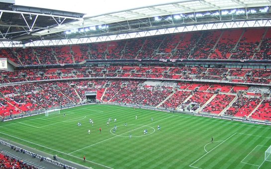 Wembley Stadium interior with fans and a game being played