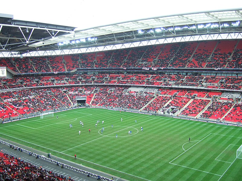Wembley Stadium interior with fans and a game being played