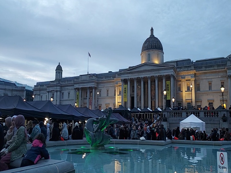 A shot of Trafalgar Square, looking back towards the National Art gallery, with the blue fountain pool in the foreground.