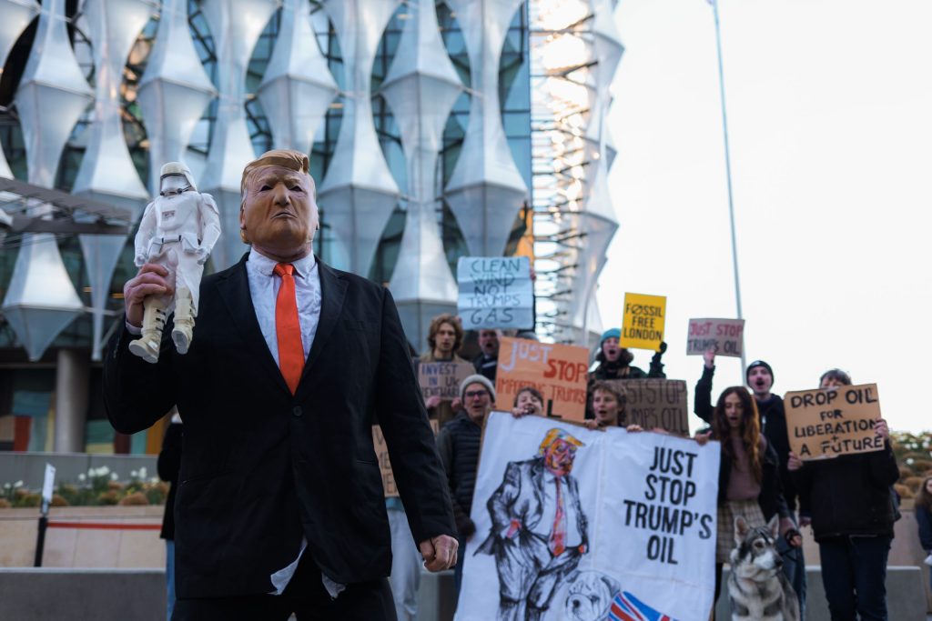 A Donald Trump impersonator holds up a stormtrooper figure