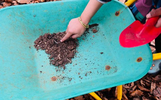Nursery children playing with dirt