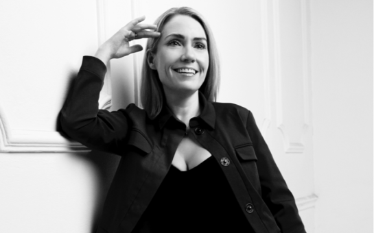 Emily Saunders smiling for a photo that has been colored in black and white.