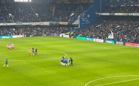 Chelsea and Arsenal players in pre-match huddles at Stamford Bridge before kick-off in a WSL match