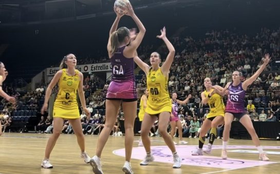 Image of two netball teams locked in action