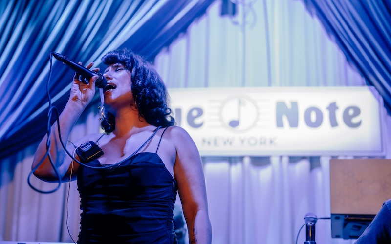 BRIT award winner Raye singing at Blue Note's New York venue. (Picture credit: Dervon Dixon)