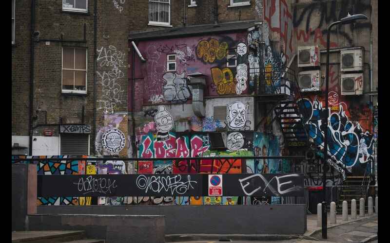 A wall of houses with graffiti