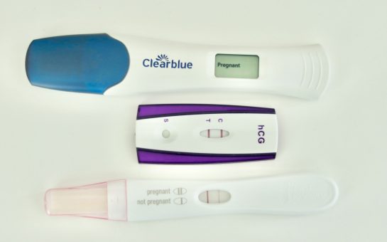 An image of three positive pregnancy tests
