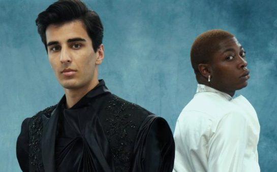 Two models wearing Spencer Thornton's graduate show collection on a blue textured backdrop.