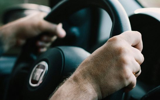 A driver at the wheel (Credit: Free to use from Unsplash)