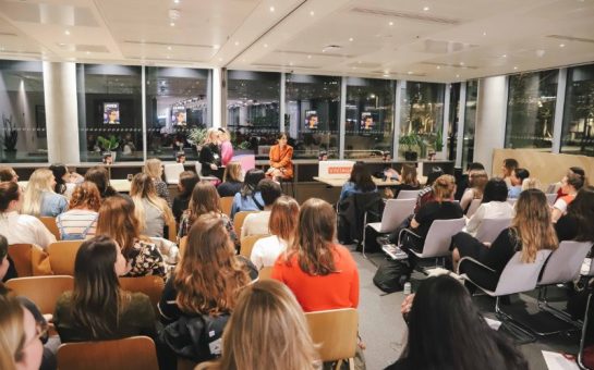 A photo of the book club in action in a conference hall.