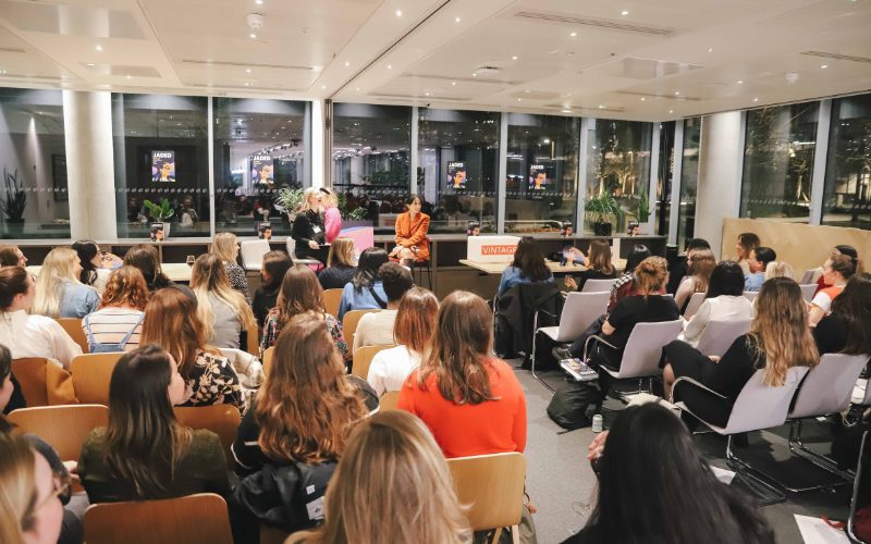 A photo of the book club in action in a conference hall.