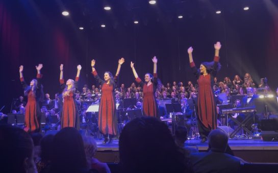 traditional Arabic dancers on stage with the orchestra