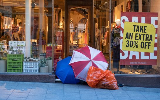 Umbrellas and tent set up in a shop doorway.