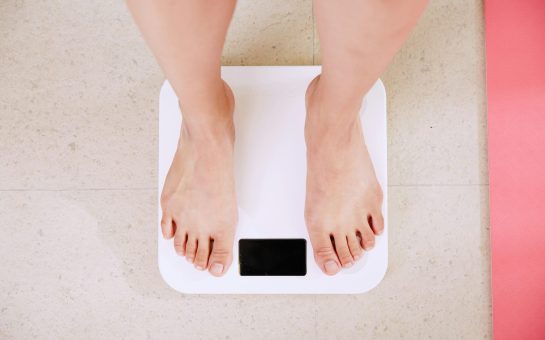 Person standing on scales (Credit: Free to use from Unsplash)