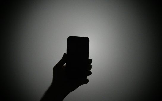 Person holding a smartphone (Credit: Free to use from Unsplash)