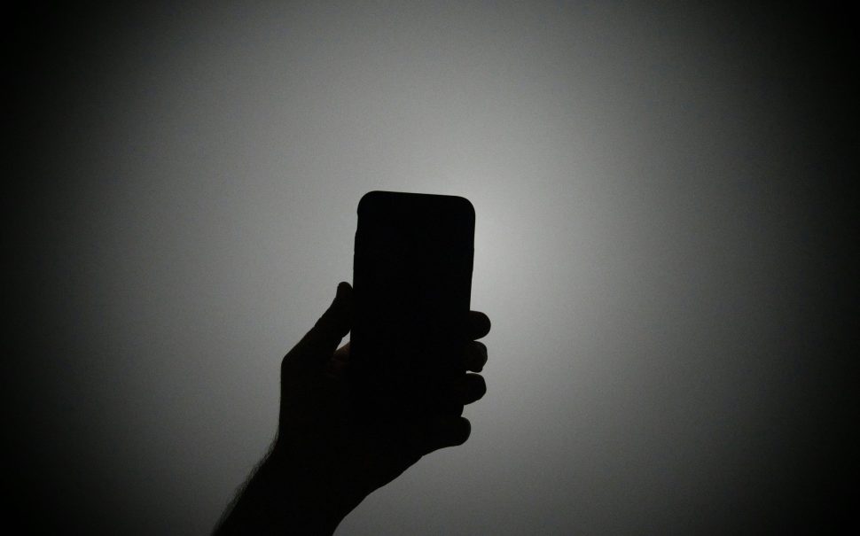 Person holding a smartphone (Credit: Free to use from Unsplash)