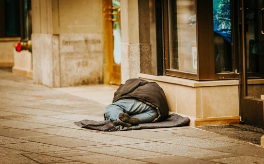 A homeless person sleeping on the street (Credit: Free to use from Unsplash)