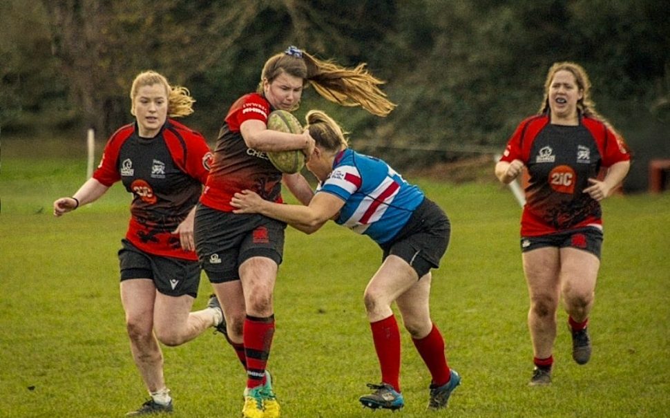 A London Irish Women's Rugby player being tackled by the opposition