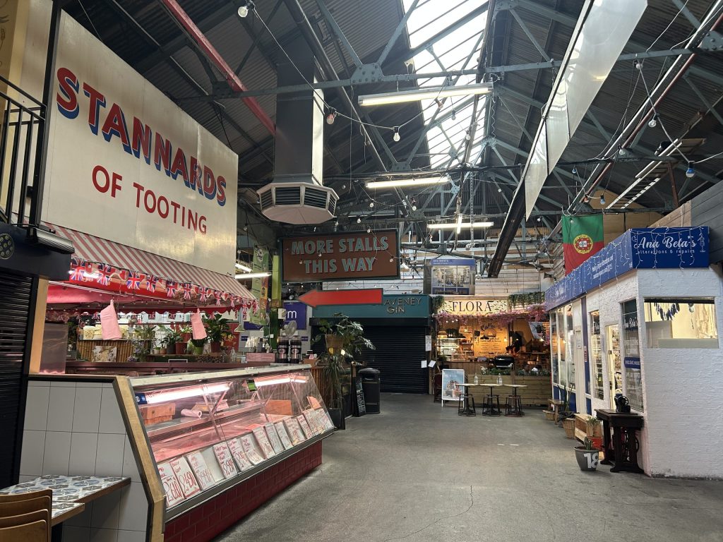 Tooting's famous food and drink market, with a stall named 'Stannards of Tooting' on the left.
