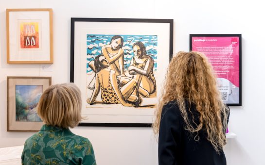 two women looking at a painting at the Affordable art fair in battersea